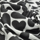 Вискоза плательно-блузочная жаккардовая, на белом фоне черные сердечки